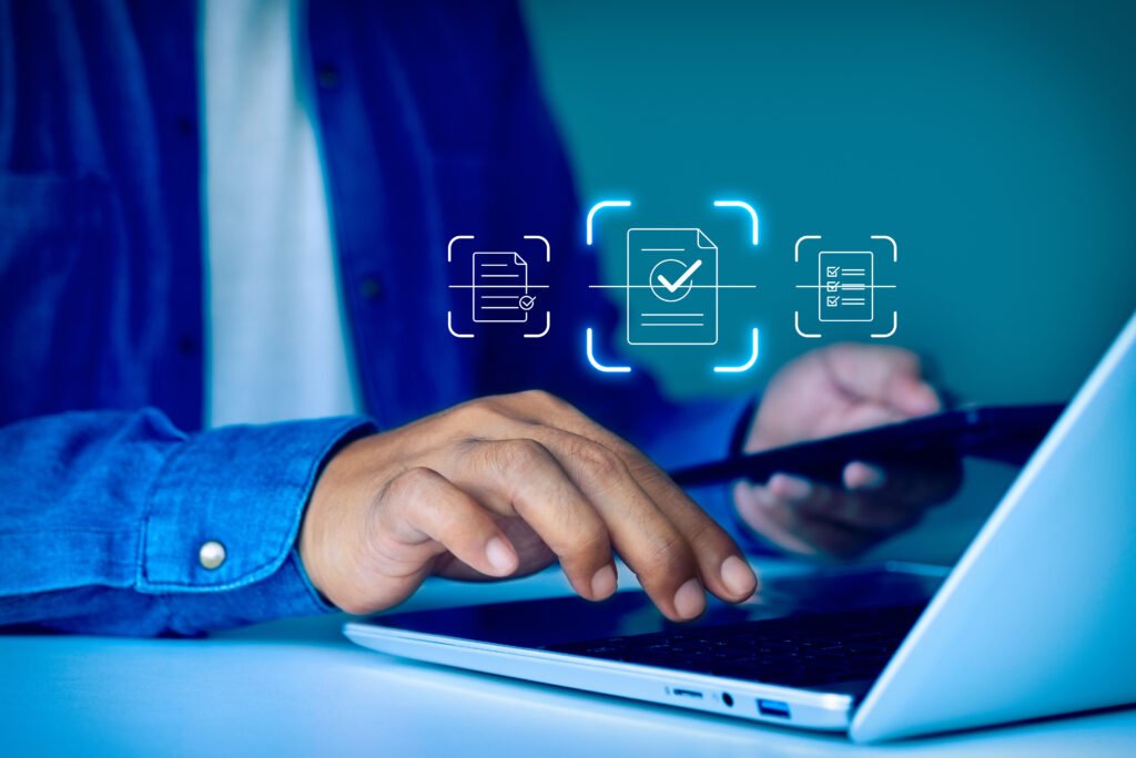 Person using laptop with digital document management icons